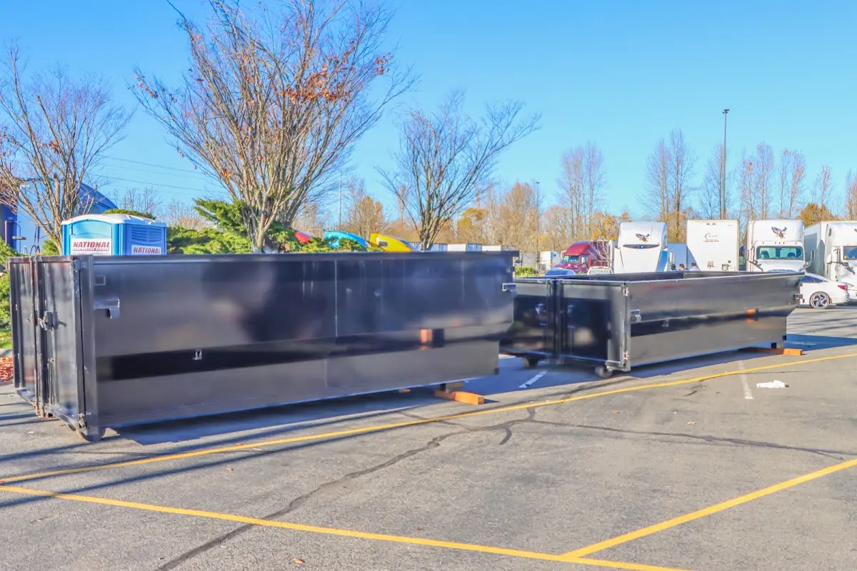 Professional dumpster rental service with roll-off container on residential driveway in Sandusky